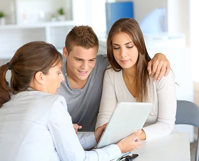 young couple reviewing mortgage options with adviser