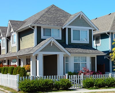 nice new 2 storey home with white picket fence