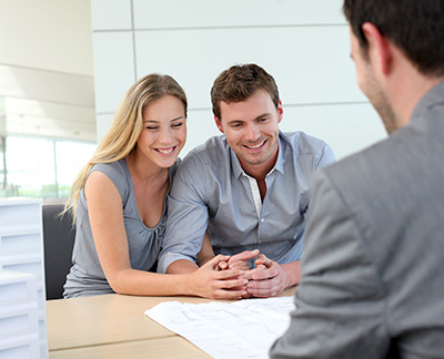 Couple asking about available buyer assistance programs